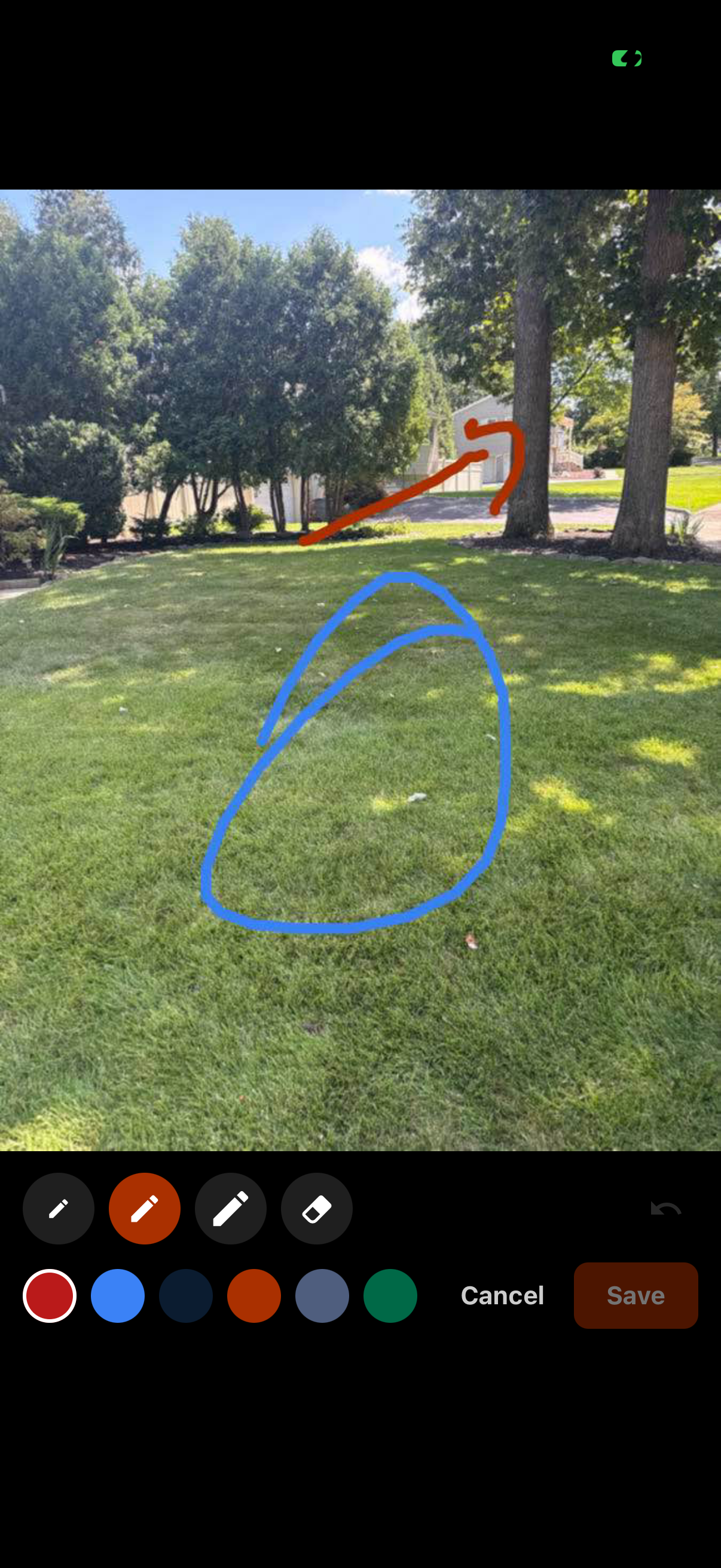 Drawing directly on a job photo with a colored pencil tool: a line marking a path and a circle around a spot on the lawn.